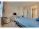 Bright bedroom with blue bedding, carpet, and ample natural light streaming through the windows at 8944 Skye Canyon Ranch St, Las Vegas, NV 89166