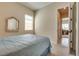 A secondary bedroom featuring carpet flooring, neutral walls, and a Queen bed with blue covers at 8944 Skye Canyon Ranch St, Las Vegas, NV 89166