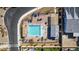 Aerial view of the community pool area featuring lounge chairs, pergola, and inviting turquoise water at 8944 Skye Canyon Ranch St, Las Vegas, NV 89166