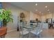 Bright dining area with tile floors, modern table, and open view into the kitchen at 8944 Skye Canyon Ranch St, Las Vegas, NV 89166