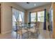 Open dining space with access to the backyard featuring a glass table and modern decor at 8944 Skye Canyon Ranch St, Las Vegas, NV 89166