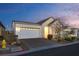 Attractive home featuring a two-car garage, desert landscaping, and a well-maintained front yard at 8944 Skye Canyon Ranch St, Las Vegas, NV 89166