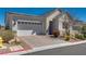 Inviting one-story home with a paved driveway leading to an attached two-car garage at 8944 Skye Canyon Ranch St, Las Vegas, NV 89166