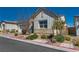 Charming single-story home with stone accents, lush landscaping, and a two-car garage at 8944 Skye Canyon Ranch St, Las Vegas, NV 89166
