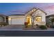 Charming single-story home featuring a brick driveway, two-car garage, and tasteful landscaping at 8944 Skye Canyon Ranch St, Las Vegas, NV 89166