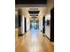 Bright hallway features wood floors, modern lighting, and access to various areas of the building at 8944 Skye Canyon Ranch St, Las Vegas, NV 89166