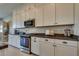 Bright kitchen featuring white cabinets, stainless steel appliances, and dark countertops at 8944 Skye Canyon Ranch St, Las Vegas, NV 89166