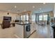 Gourmet kitchen with a large island, modern appliances, and an open view to the living and dining areas at 8944 Skye Canyon Ranch St, Las Vegas, NV 89166