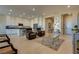Open-concept living room with tile flooring, modern furniture, and recessed lighting at 8944 Skye Canyon Ranch St, Las Vegas, NV 89166