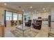 Spacious living area with lots of natural light flowing seamlessly into the kitchen and dining areas at 8944 Skye Canyon Ranch St, Las Vegas, NV 89166