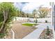 Landscaped backyard with rocks, small lawn and concrete, offering a serene outdoor space at 9004 Crystal Glass Dr, Las Vegas, NV 89117