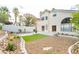 Landscaped backyard with an artificial turf area, desert landscaping, and partial home view at 9004 Crystal Glass Dr, Las Vegas, NV 89117