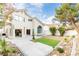Backyard showcasing a manicured lawn, desert landscaping, and the home's architectural design at 9004 Crystal Glass Dr, Las Vegas, NV 89117