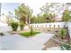 A well-kept backyard features a tidy lawn, rock landscaping and a serene outdoor space at 9004 Crystal Glass Dr, Las Vegas, NV 89117