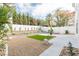 Manicured backyard with artificial lawn, rock features, and mature landscaping for relaxed outdoor living at 9004 Crystal Glass Dr, Las Vegas, NV 89117
