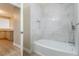 Elegant bathroom featuring a soaking tub with marble-look tile surround and modern fixtures at 9004 Crystal Glass Dr, Las Vegas, NV 89117