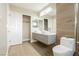 Modern bathroom showcasing a dual sink vanity, wood-look tile flooring, and contemporary fixtures at 9004 Crystal Glass Dr, Las Vegas, NV 89117