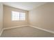 Cozy bedroom with neutral carpet, baseboards, and a window providing natural light at 9004 Crystal Glass Dr, Las Vegas, NV 89117