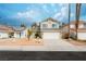 Charming two story home featuring a two car garage and desert landscaping at 9004 Crystal Glass Dr, Las Vegas, NV 89117