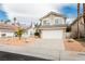 Two story home with a two car garage, desert landscaping, and bright blue skies at 9004 Crystal Glass Dr, Las Vegas, NV 89117