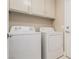 This laundry room features a side by side washer and dryer and upper cabinets at 9004 Crystal Glass Dr, Las Vegas, NV 89117