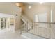 Spacious living room includes a staircase, modern tile floors, and a wet bar at 9004 Crystal Glass Dr, Las Vegas, NV 89117
