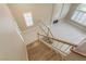 This stairway shows the light and bright living room with the fireplace below at 9004 Crystal Glass Dr, Las Vegas, NV 89117