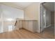 Bright loft area featuring wood-look flooring, built-in cabinets, and staircase leading to a lower level at 9004 Crystal Glass Dr, Las Vegas, NV 89117