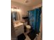 Well-lit bathroom features updated vanity with sink and blue floral shower curtain at , Las Vegas, NV 89122