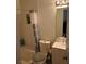 Cozy bathroom featuring a shower with tiled bench, neutral gray curtain, and a white sink vanity at , Las Vegas, NV 89122