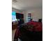Cozy bedroom with a large television, light wood floors, and blue sky visible through the window at , Las Vegas, NV 89122