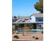 Community pool featuring a pergola surrounded by landscaping in front of townhouses with blue trim and roofs at , Las Vegas, NV 89122