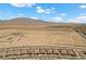 Sweeping aerial view of desert landscape with new construction and mountain backdrop at 10158 Super Jovian St, Las Vegas, NV 89143