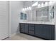 Stylish bathroom showcasing double sinks, modern cabinetry, and a large mirror with great lighting at 10158 Super Jovian St, Las Vegas, NV 89143