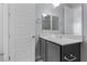 Bright bathroom features gray vanity, a double mirror and white doors at 10158 Super Jovian St, Las Vegas, NV 89143
