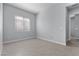 Bright, tile-floored bedroom with large window and neutral walls at 10158 Super Jovian St, Las Vegas, NV 89143
