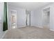 Spacious carpeted bedroom showcasing multiple doorways and windows offering natural light at 10158 Super Jovian St, Las Vegas, NV 89143