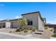 Stylish single-story home featuring desert landscaping, a two-car garage and a brick walkway under a clear blue sky at 10158 Super Jovian St, Las Vegas, NV 89143