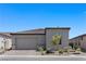 Charming single-story home showcasing desert landscaping, tile roof, and a two-car garage at 10158 Super Jovian St, Las Vegas, NV 89143