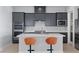 Modern kitchen features gray cabinetry, stainless steel appliances, and a center island with seating at 10158 Super Jovian St, Las Vegas, NV 89143