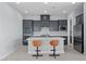 Modern kitchen features a center island, gray cabinetry, stainless steel appliances, and stylish seating at 10158 Super Jovian St, Las Vegas, NV 89143