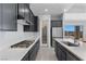 Sleek kitchen boasts stainless steel appliances, a gas cooktop, pantry, and an island with sink and dishwasher at 10158 Super Jovian St, Las Vegas, NV 89143