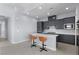Stylish kitchen with gray cabinets, white countertops, island seating, and stainless-steel appliances at 10158 Super Jovian St, Las Vegas, NV 89143