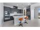 Open kitchen with gray cabinets, stainless steel appliances, a center island with seating, and tile flooring at 10158 Super Jovian St, Las Vegas, NV 89143
