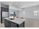 Bright, open kitchen and living area with stainless steel appliances, tile flooring, and plenty of natural light at 10158 Super Jovian St, Las Vegas, NV 89143