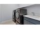 Practical laundry room with washer, dryer, and a sink for added convenience at 10158 Super Jovian St, Las Vegas, NV 89143