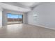 Bright living room boasts neutral tile flooring, large sliding glass doors, and ample natural light at 10158 Super Jovian St, Las Vegas, NV 89143
