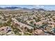 Expansive aerial view of the residential area with diverse homes, convenient access to amenities, and mountain views at 10563 Sunblower Ave, Las Vegas, NV 89135