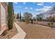 Expansive backyard featuring low-maintenance gravel landscaping and mature trees, perfect for outdoor enjoyment at 10563 Sunblower Ave, Las Vegas, NV 89135
