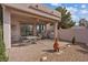 Covered outdoor patio overlooking the backyard, equipped with a grill at 10563 Sunblower Ave, Las Vegas, NV 89135